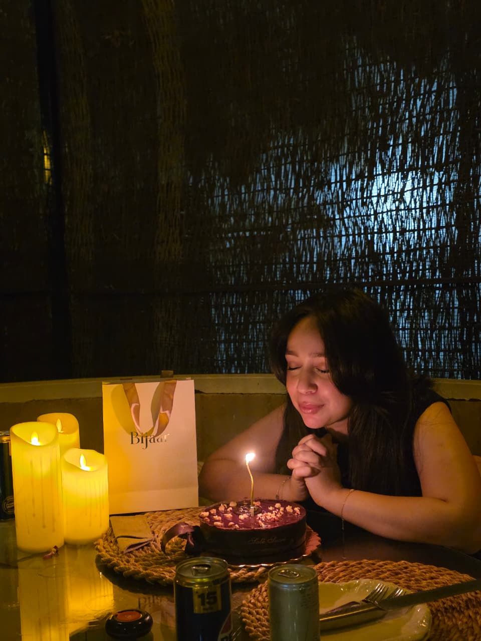 Margaret making a wish by candlelight